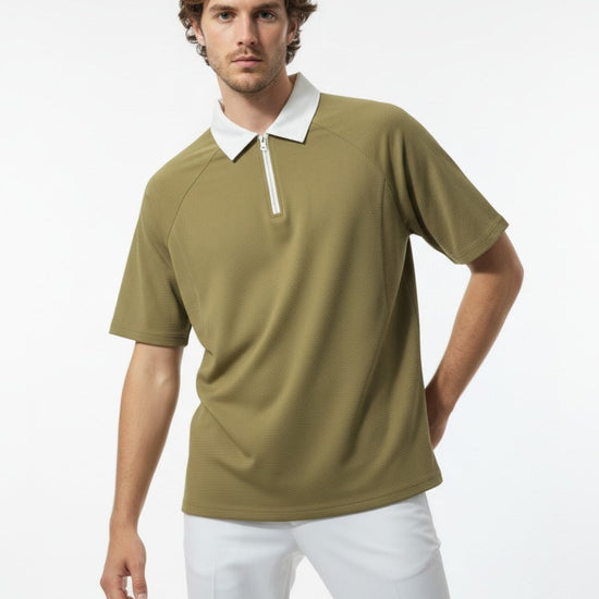 Man wearing a green polo shirt with a white collar on a white background