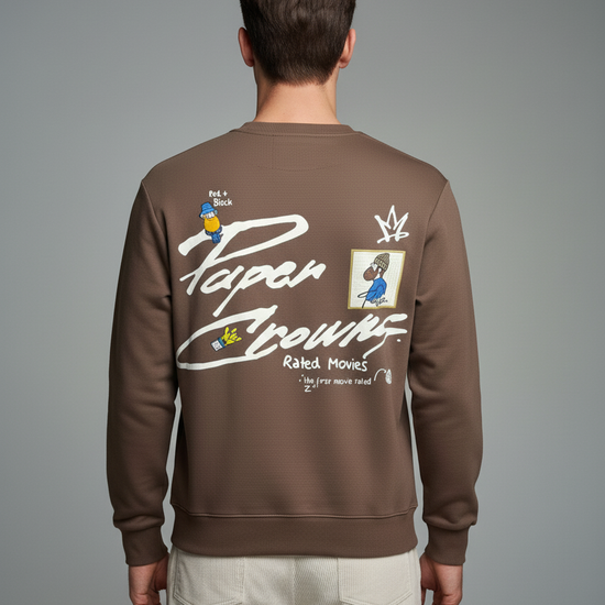 Person wearing a brown sweatshirt with graphics and text on the back